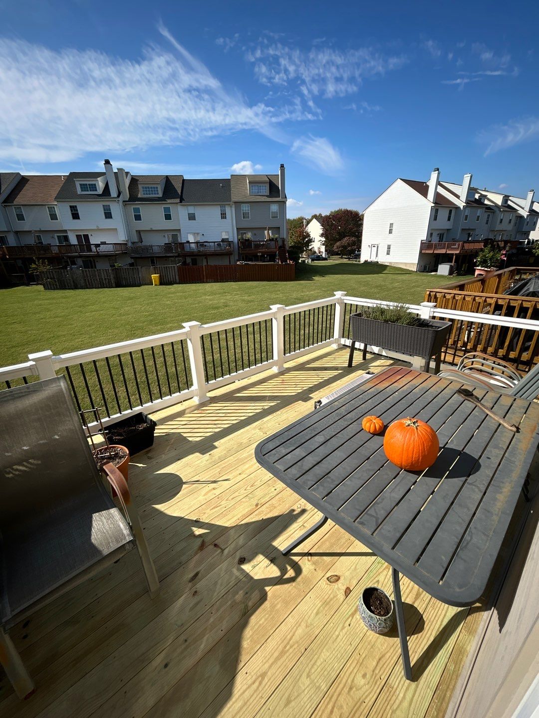 Sunlit deck with pumpkins on patio table