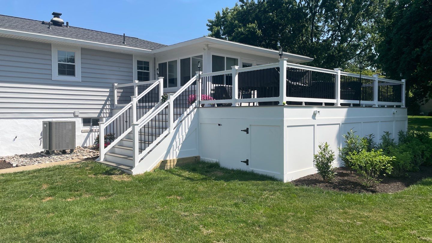 Raised white deck with stairs and lawn