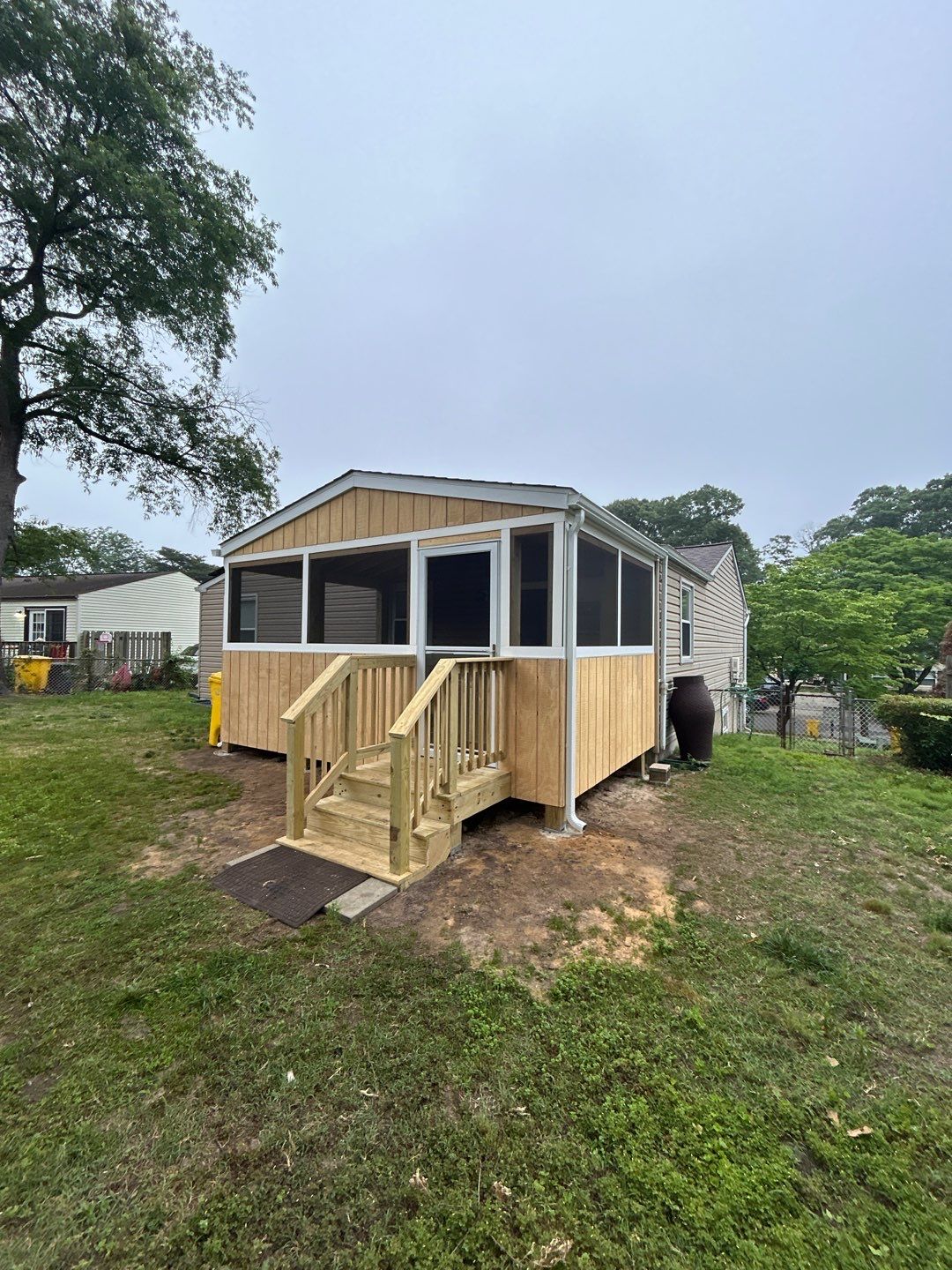 Raised screened porch addition on small home