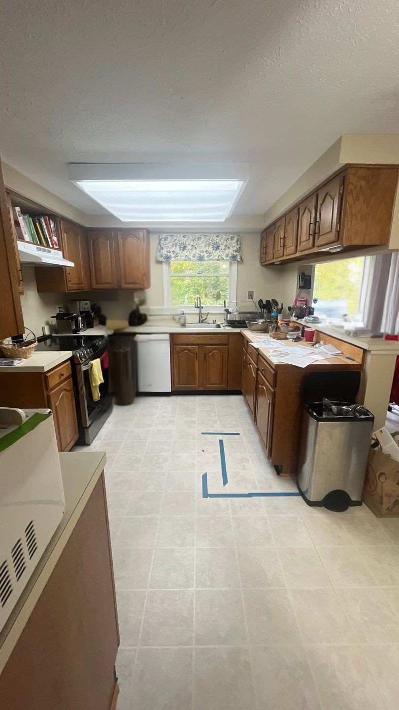 Remodeling contractor reviewing kitchen plans inside a Severn, MD home.
