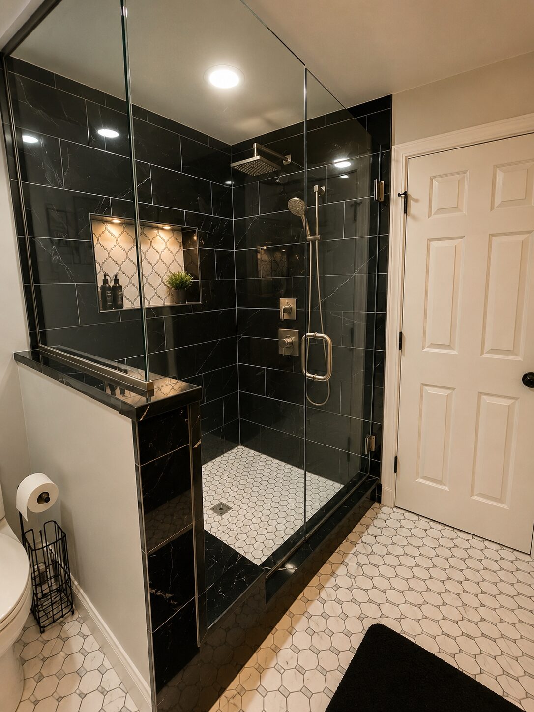 Modern black-tiled glass shower with hexagon flooring